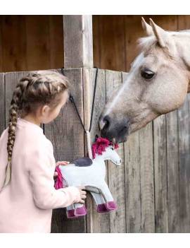 niña y caballo juganco con juguete para caballo en forma de unicornio rosa con botella